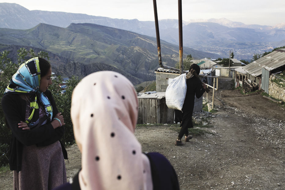 Woman carrying a heavy load.