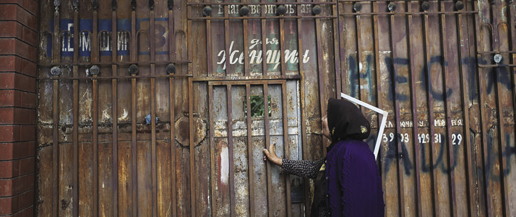 Woman standing in front of gate