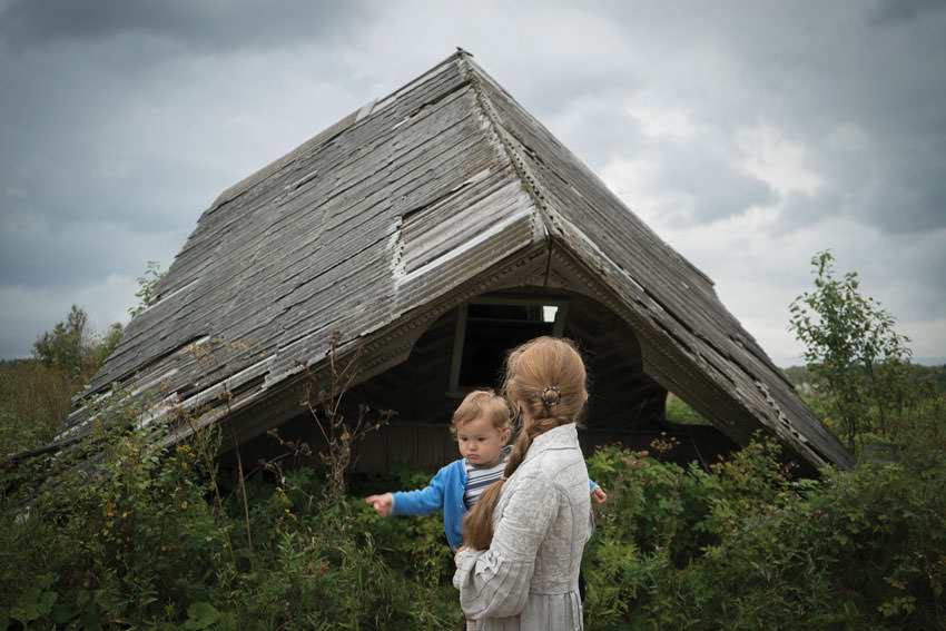 Woman and child looking at fallen building