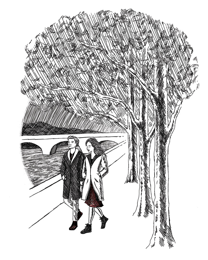 Man and woman walking along a river.