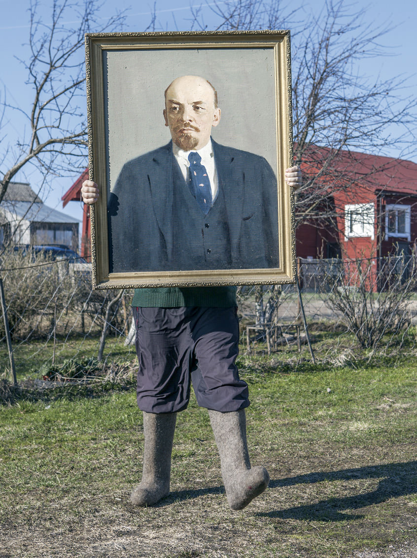 Man carrying portrait of Lenin.
