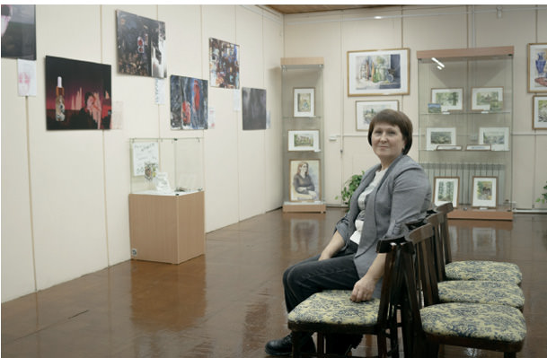 Woman in museum looking at camera.