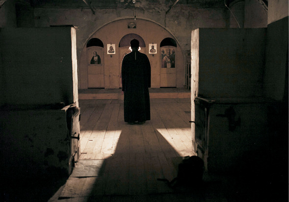 Priest standing in a church.