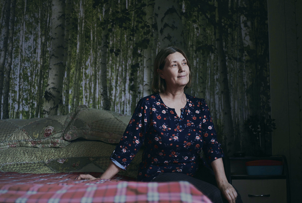 Woman sitting on a bed.