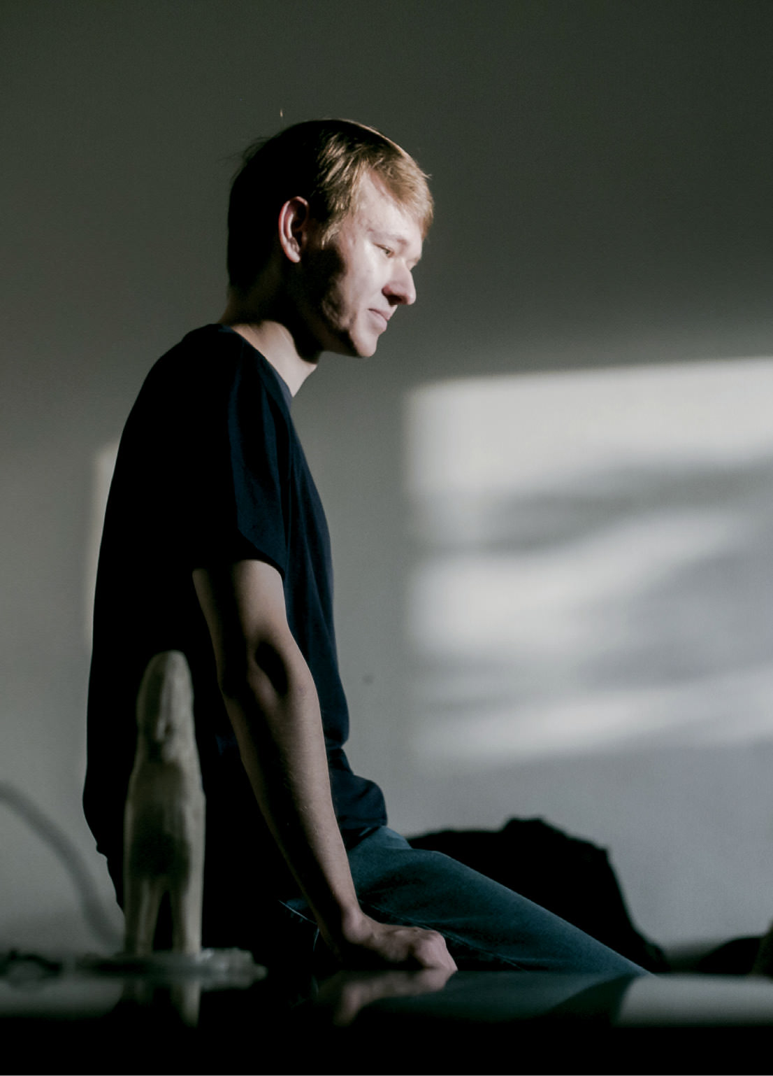 Young man sitting on a table.