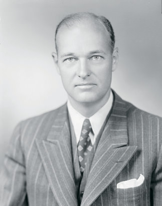 Man posing for photo in a suit.