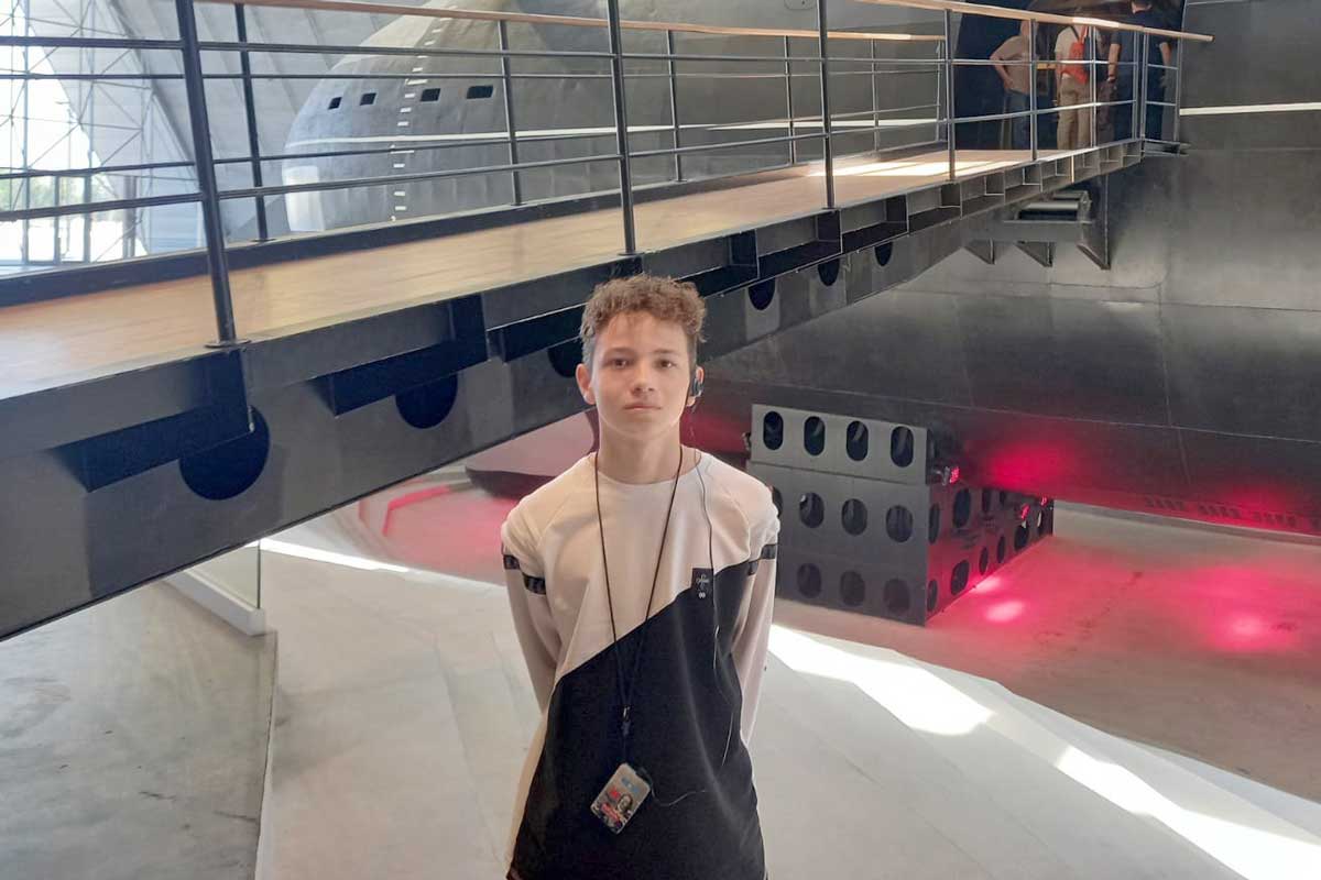 Boy standing in a museum.