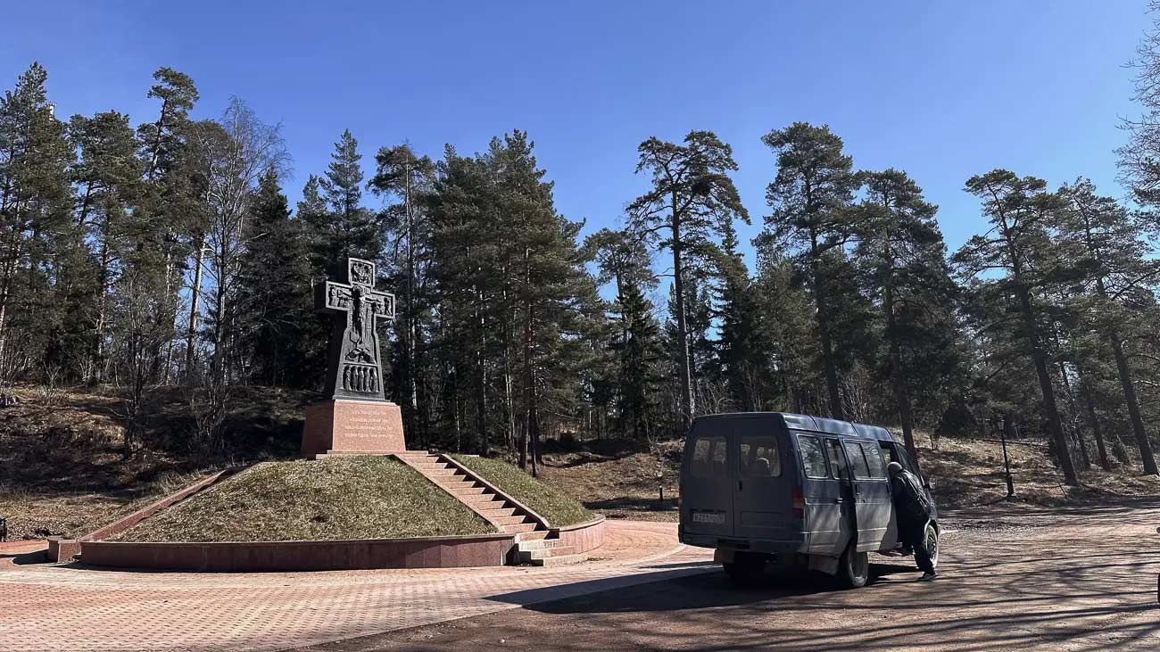 A bus stopped before a religious monument.