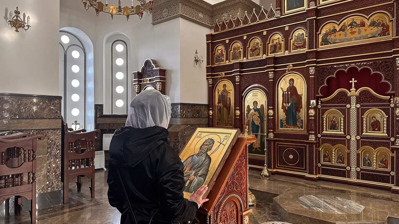 Woman praying in Russian church.