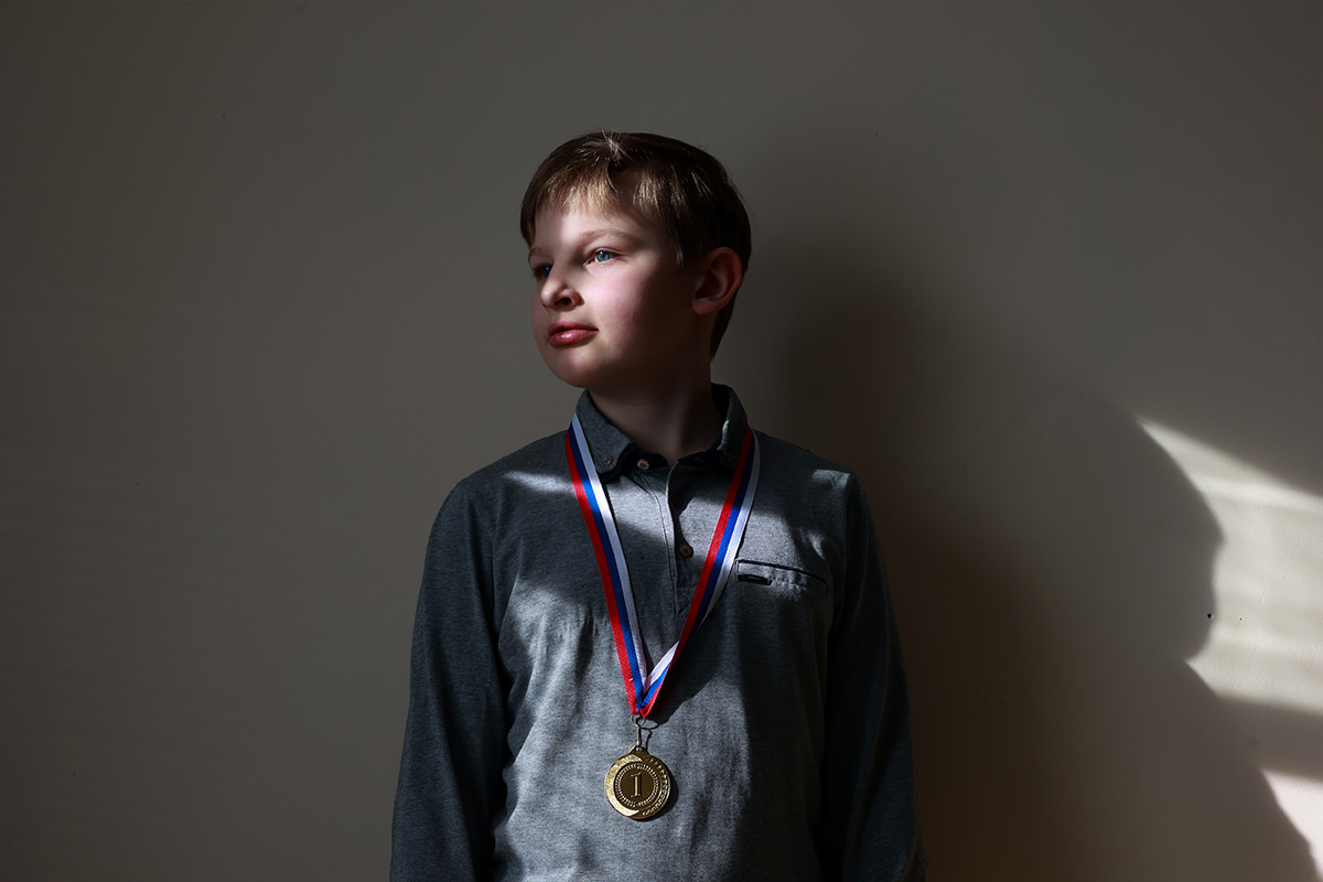 Boy sporting a gold medal.